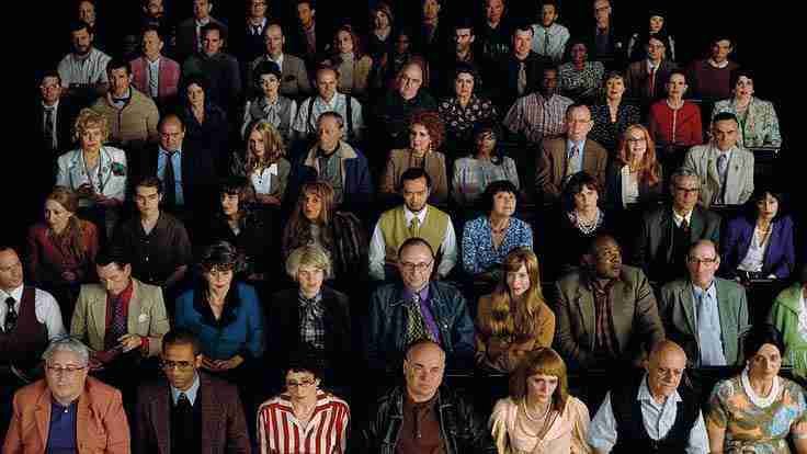 Diverse audience seated in a theater setting, capturing attention and engagement, relevant to creating effective video marketing strategies.