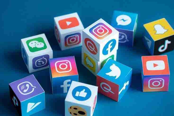 Colorful cubes displaying various social media platform logos on a blue background, representing social media marketing strategies.