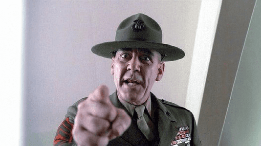 Sergeant in military uniform points forward, emphasizing assertive communication, relevant to video marketing strategies.